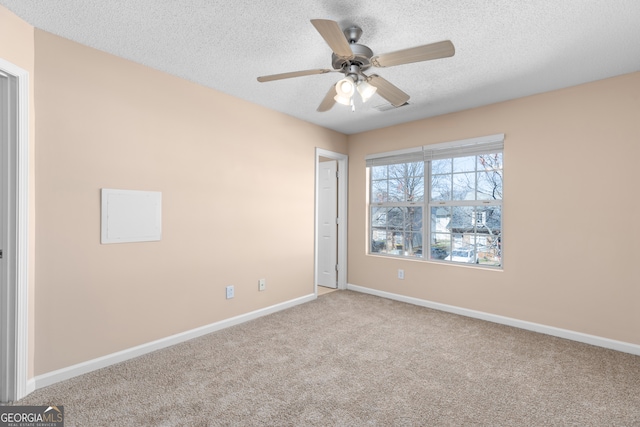 carpeted empty room featuring a textured ceiling and ceiling fan