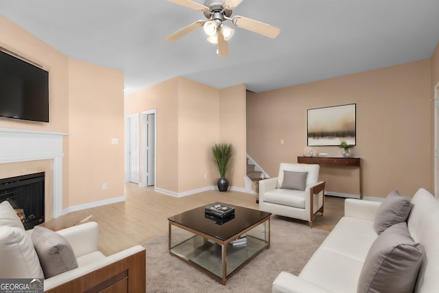 living room with ceiling fan and hardwood / wood-style floors