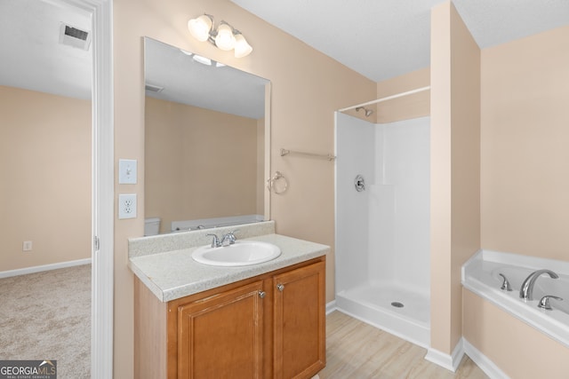 bathroom featuring vanity and shower with separate bathtub