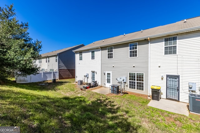 back of house featuring a yard, central AC, and a patio area