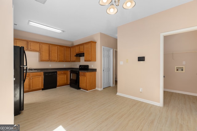 kitchen featuring black appliances, light hardwood / wood-style flooring, and sink