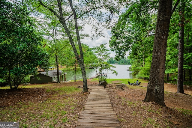 view of yard featuring a dock and a water view