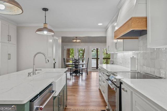 kitchen with custom exhaust hood, stainless steel appliances, and white cabinetry