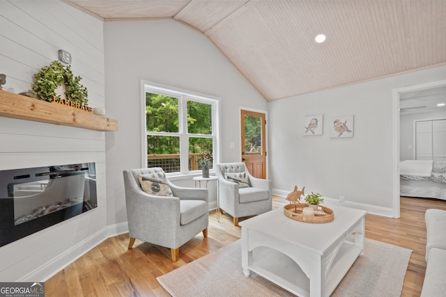 living room featuring lofted ceiling, wooden ceiling, and light hardwood / wood-style flooring