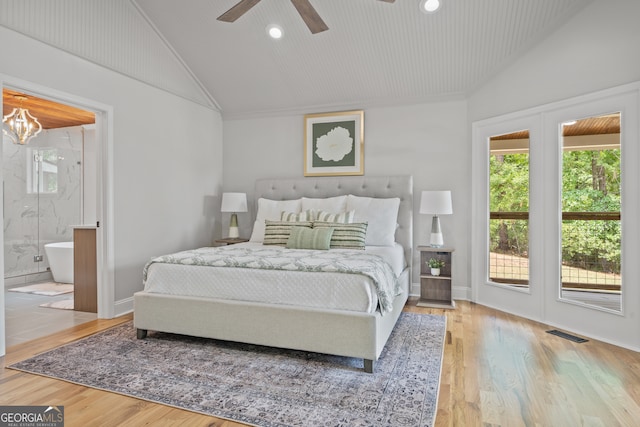 bedroom featuring lofted ceiling, ceiling fan, hardwood / wood-style floors, connected bathroom, and access to exterior