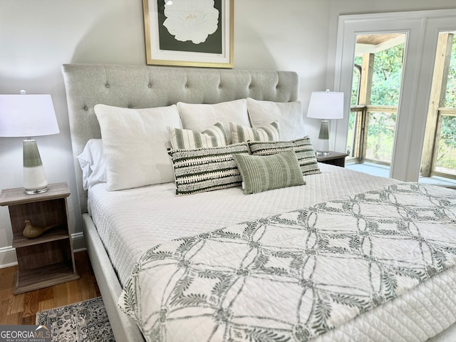 bedroom featuring access to outside and hardwood / wood-style floors