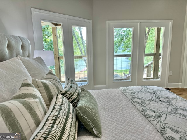 bedroom with wood-type flooring and french doors