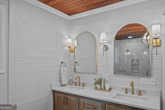 bathroom featuring wooden ceiling, crown molding, a shower with door, and vanity