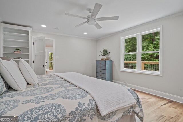 bedroom featuring ornamental molding, ceiling fan, and light hardwood / wood-style flooring