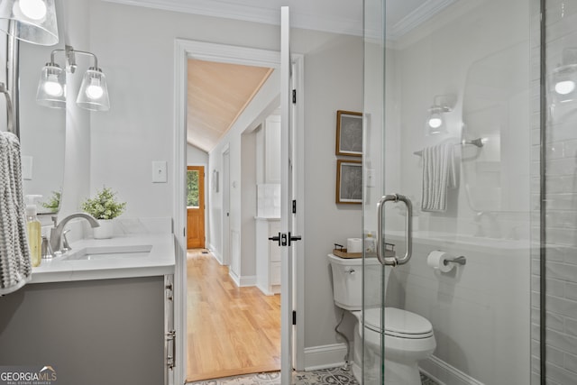 bathroom with vanity, ornamental molding, hardwood / wood-style flooring, walk in shower, and toilet