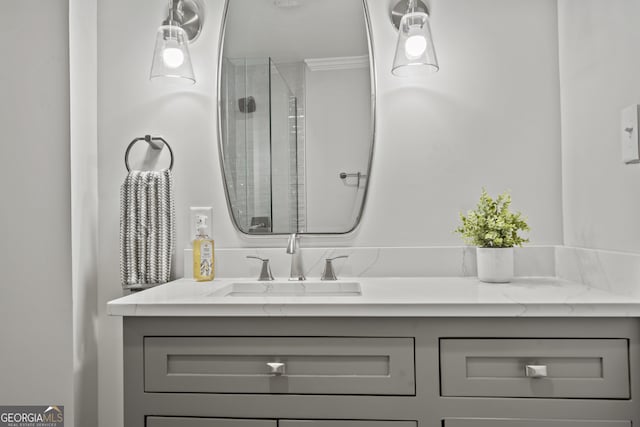 bathroom with ornamental molding, an enclosed shower, and vanity