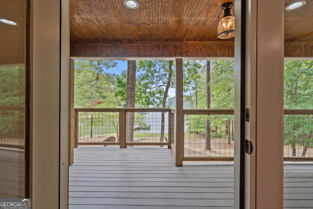 doorway to outside with hardwood / wood-style floors and wooden ceiling