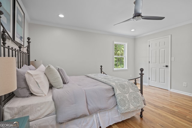 bedroom with ornamental molding, ceiling fan, and wood-type flooring