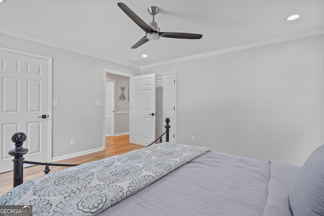 bedroom with ceiling fan, hardwood / wood-style flooring, and ornamental molding