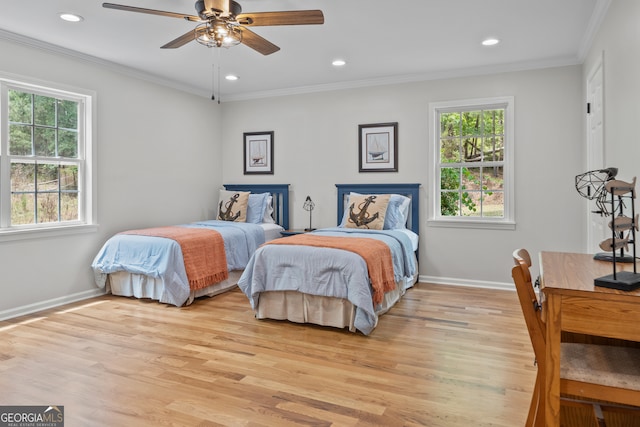 bedroom with ceiling fan, light wood-type flooring, and multiple windows