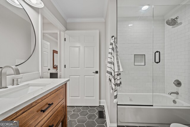 bathroom with tile patterned floors, crown molding, vanity, and enclosed tub / shower combo