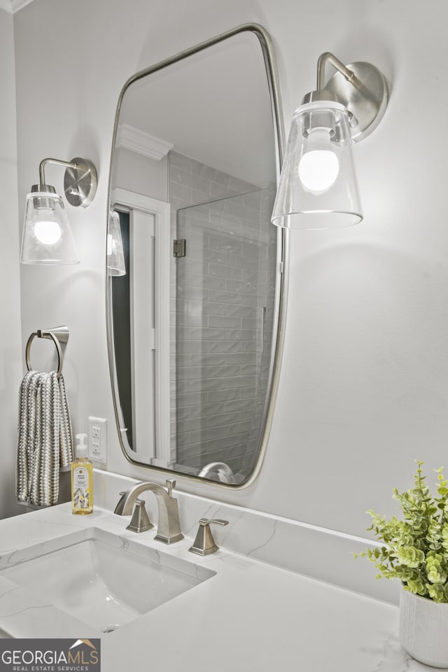 bathroom with walk in shower, vanity, and crown molding