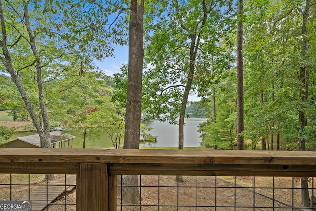 wooden terrace featuring a water view