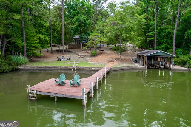 view of dock with a gazebo and a water view