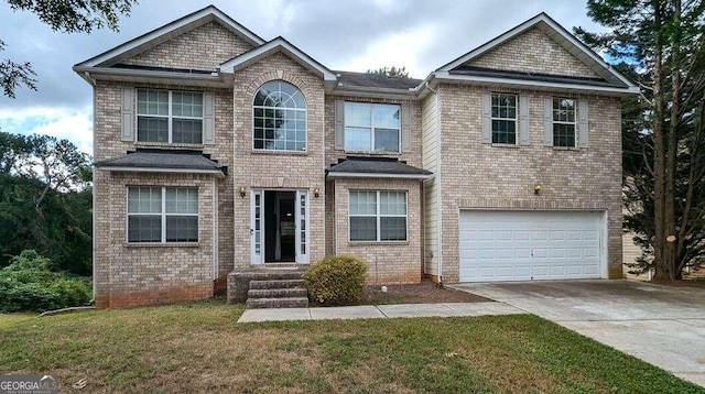 view of front property featuring a garage and a front lawn