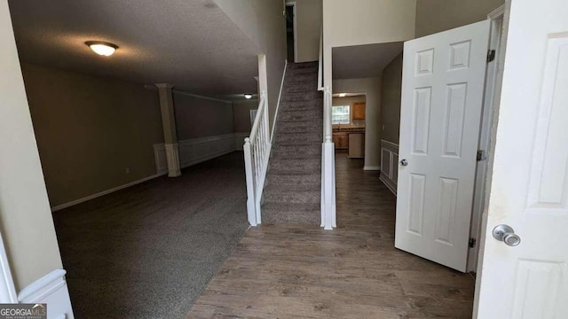 interior space with wood-type flooring and a textured ceiling