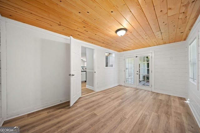 interior space featuring light hardwood / wood-style flooring, french doors, wooden walls, and wooden ceiling