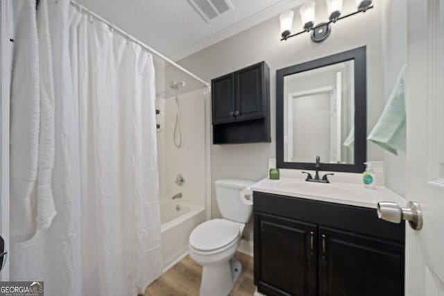 full bathroom with wood-type flooring, toilet, shower / bath combo with shower curtain, vanity, and crown molding