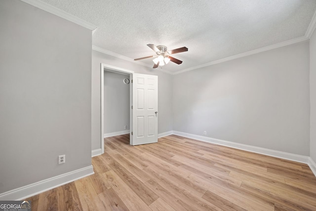 unfurnished bedroom with light hardwood / wood-style floors, crown molding, a textured ceiling, and ceiling fan