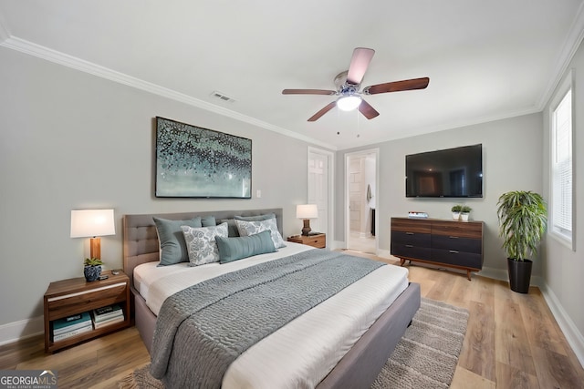 bedroom featuring ornamental molding, wood-type flooring, and ceiling fan