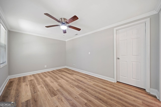 unfurnished room with crown molding, light hardwood / wood-style flooring, and ceiling fan