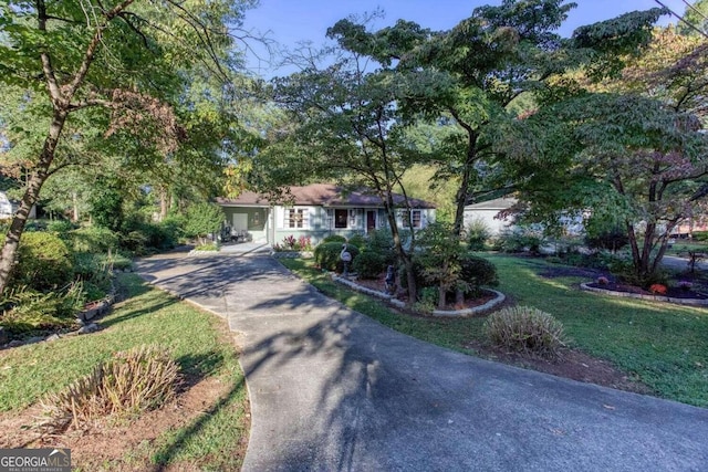 view of front of property with a front lawn and a garage