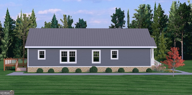 view of front facade with a front yard and a wooden deck