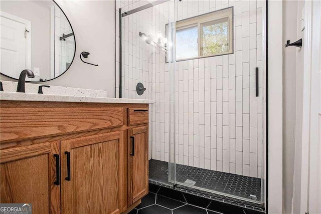 bathroom featuring a shower stall, tile patterned floors, and vanity