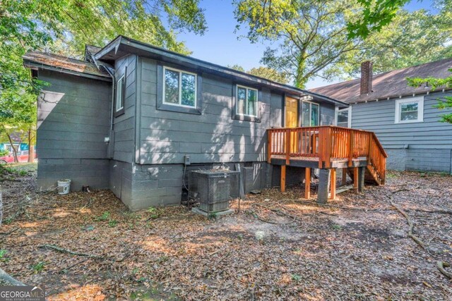 back of house featuring a deck and central AC unit