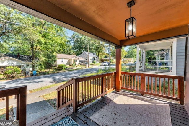 deck with a residential view and a porch