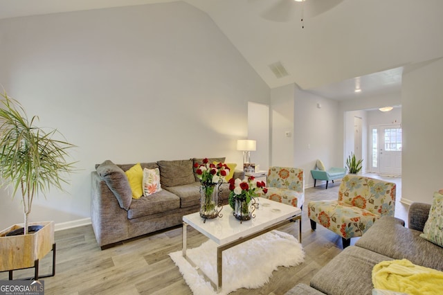 living room with high vaulted ceiling, ceiling fan, and light hardwood / wood-style floors