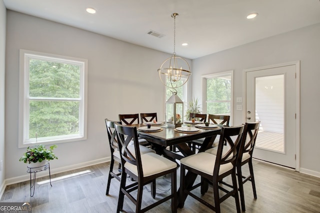 dining room with an inviting chandelier and wood-type flooring