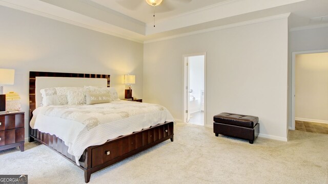 carpeted bedroom featuring ornamental molding, ensuite bath, and ceiling fan