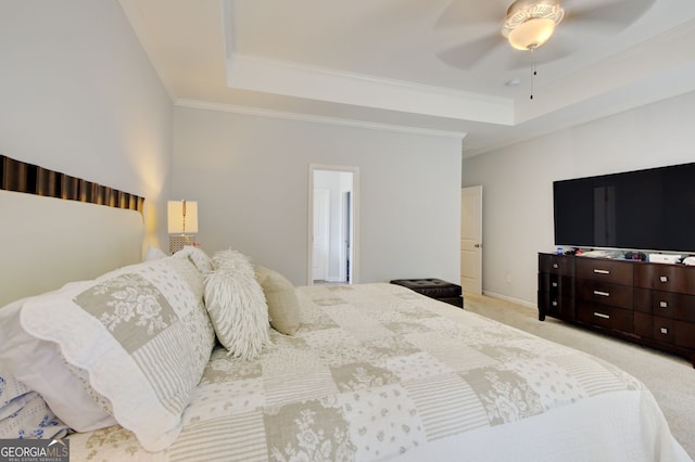 carpeted bedroom featuring ornamental molding, ceiling fan, and a raised ceiling