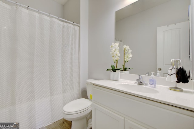 bathroom featuring a shower with curtain, hardwood / wood-style flooring, vanity, and toilet