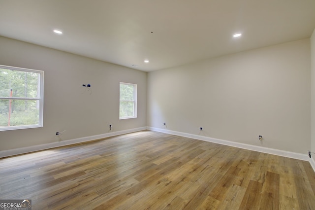 unfurnished room with light hardwood / wood-style floors