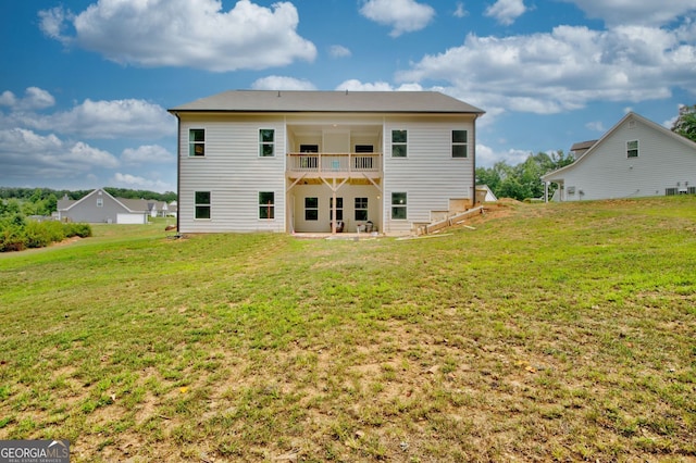 back of house featuring a yard, a patio, and a balcony