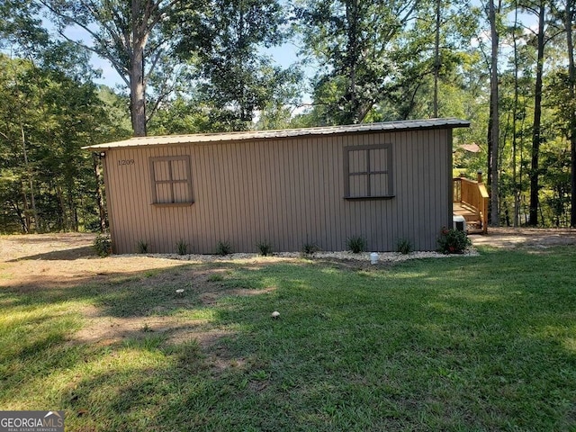 view of outdoor structure featuring a lawn