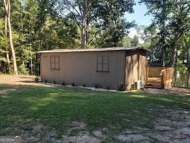 view of outbuilding with a yard and central AC