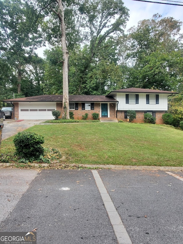 tri-level home featuring a front yard and a garage