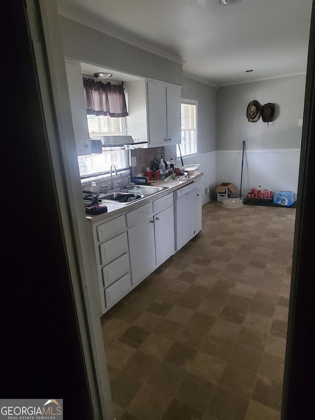 kitchen with dishwasher, white cabinetry, crown molding, and sink