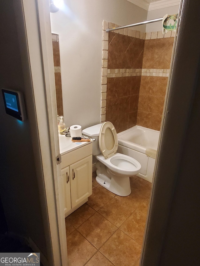 full bathroom with vanity, crown molding, tile patterned flooring, toilet, and tiled shower / bath