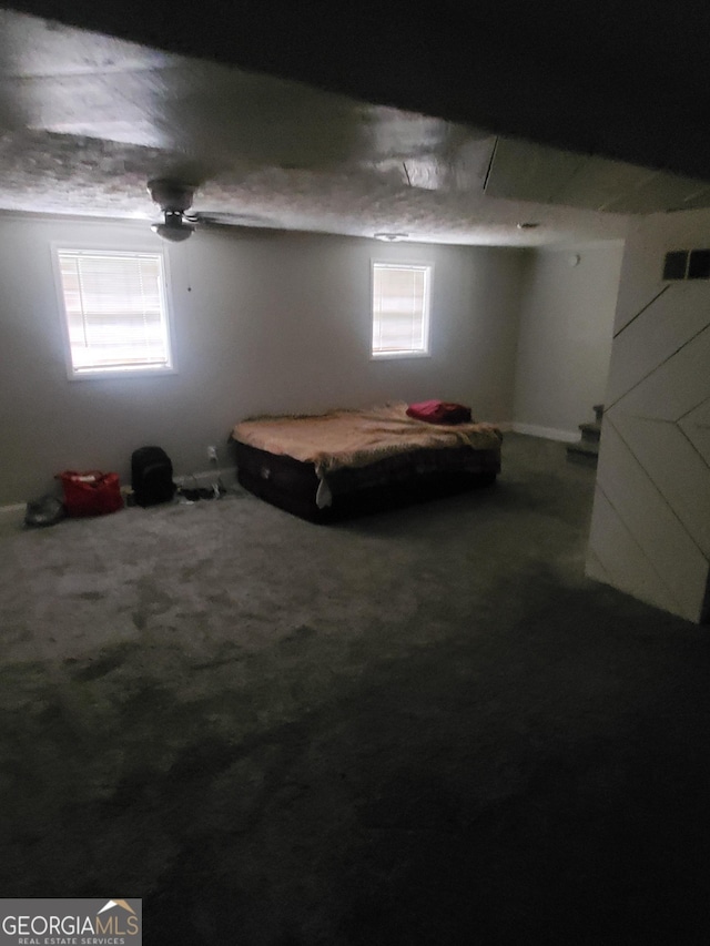 bedroom featuring multiple windows, ceiling fan, and carpet floors