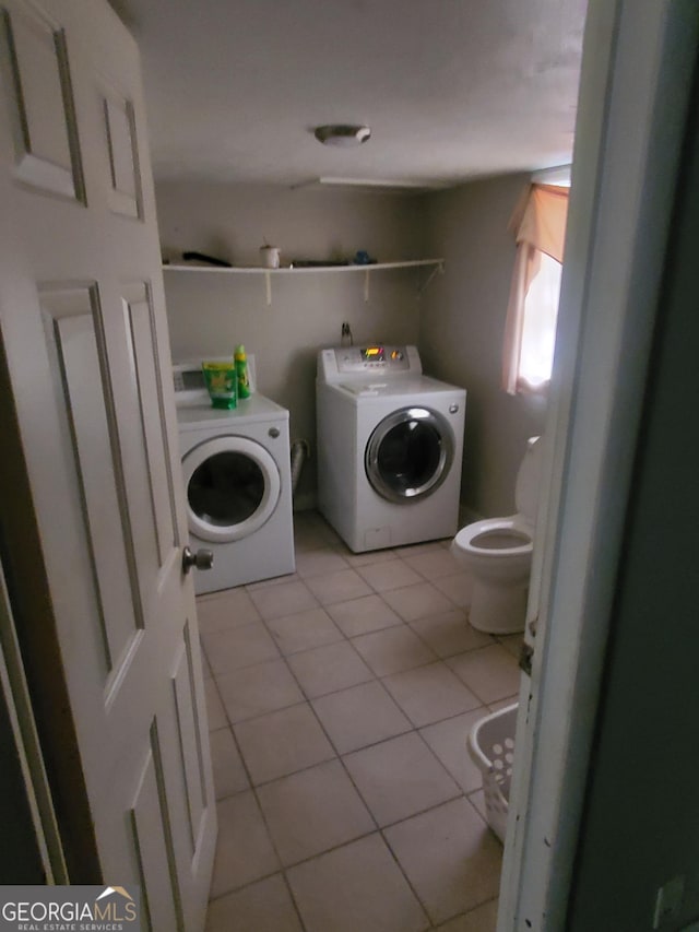 laundry room featuring independent washer and dryer and light tile patterned floors