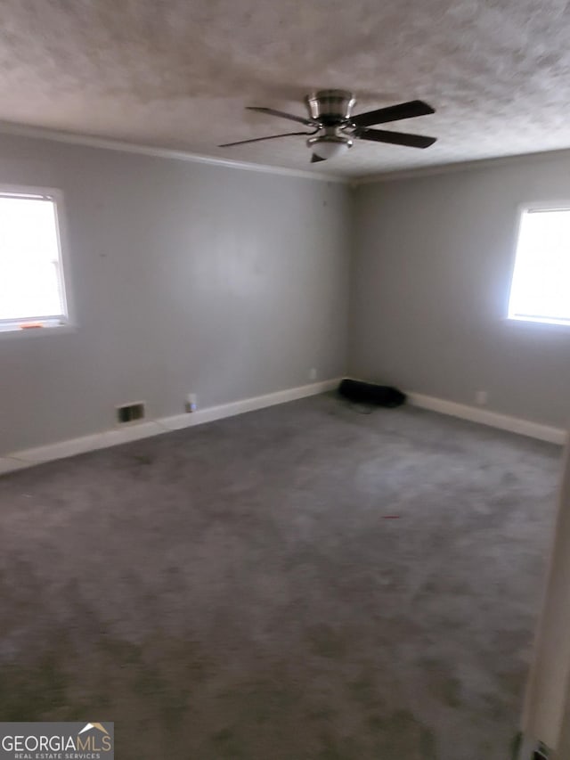 carpeted spare room featuring crown molding and ceiling fan